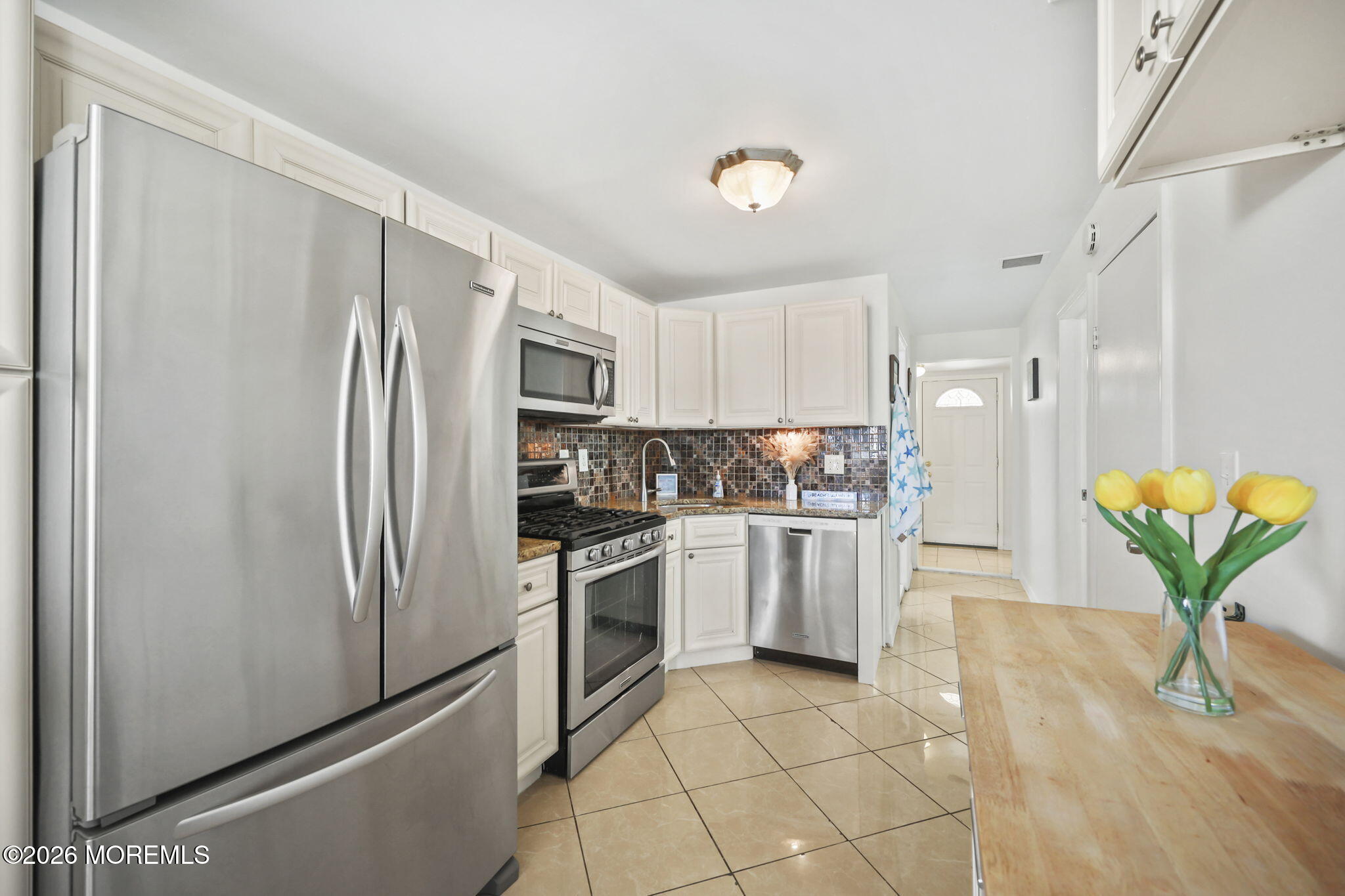 211 Ocean Avenue Point Pleasant Beach, NJ 08742 - Photo 6 of 60 a kitchen with stainless steel appliances a refrigerator sink and microwave