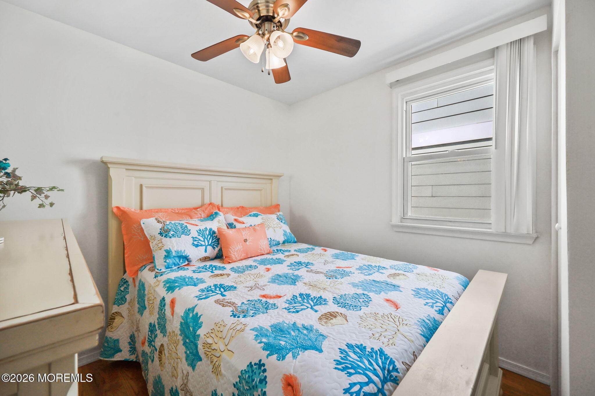 211 Ocean Avenue Point Pleasant Beach, NJ 08742 - Photo 7 of 60 a bedroom with a bed and a chandelier