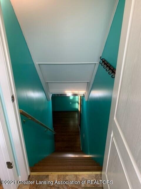 4050 Matthews Road Charlotte, MI 48813 - Photo 24 of 35 Basement Stairs with Laminate Flooring