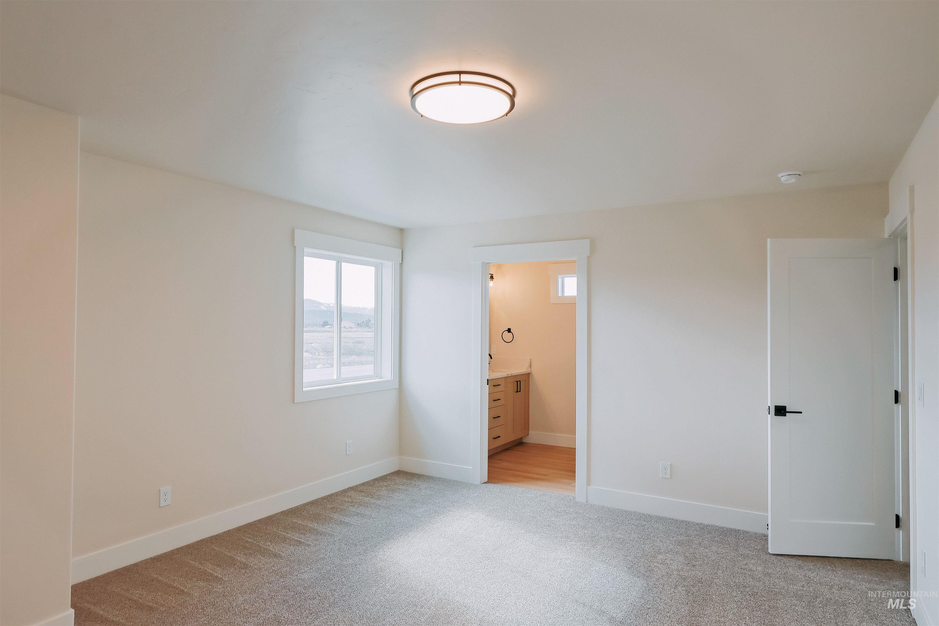 10 North Crk Way Cascade, ID 83611 - Photo 9 of 25 Unfurnished bedroom featuring light carpet and ensuite bath