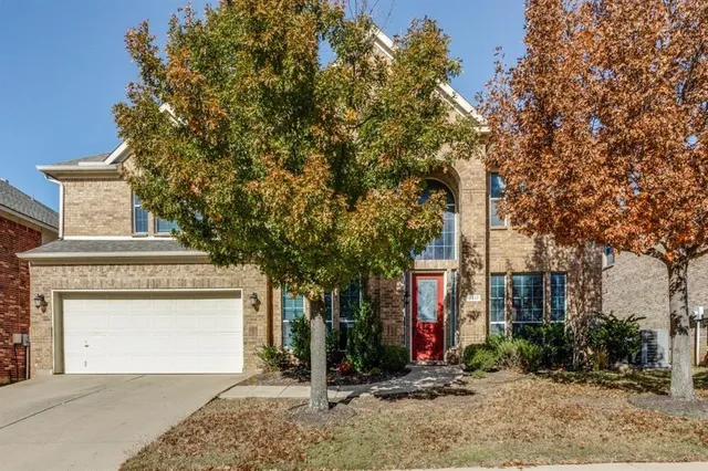 front view of a house with a tree