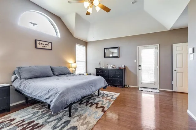 a spacious bedroom with a bed and a chandelier