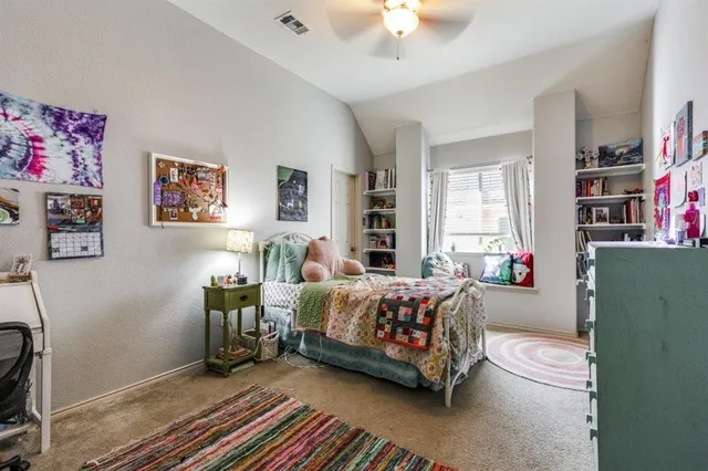 a bed room with a bed and a book shelf