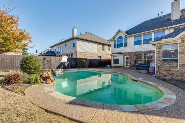 a front view of a house with a yard table and chairs