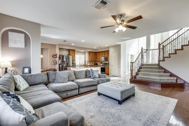 a living room with furniture and wooden floor