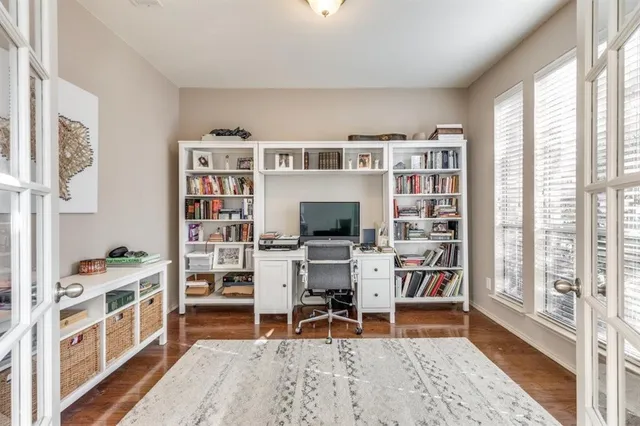a view of a workspace with furniture and a bookshelf