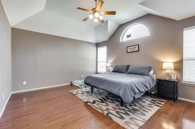 a bedroom with a large bed and a chandelier