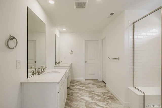 a spacious bathroom with a sink and a mirror