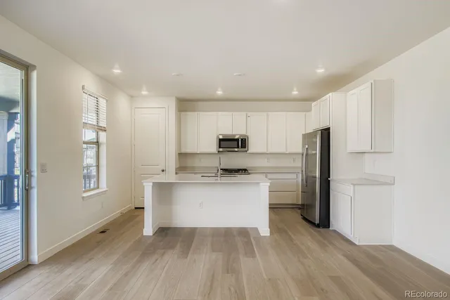 a kitchen with stainless steel appliances a refrigerator sink and cabinets