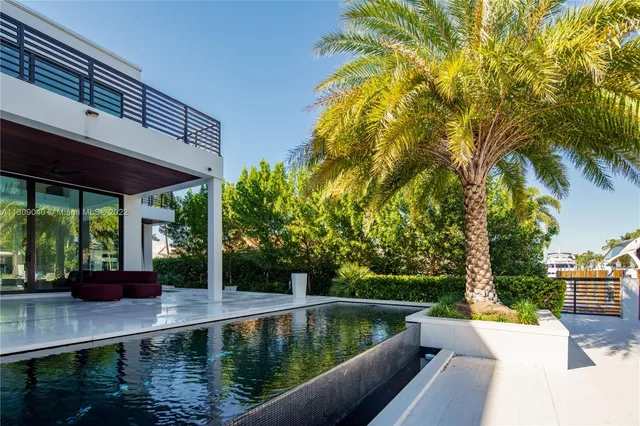 a large bedroom with a bed and large window