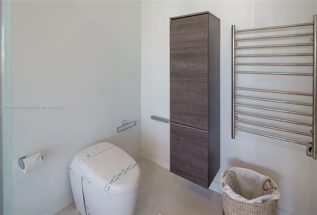 a bedroom with a large window and a balcony