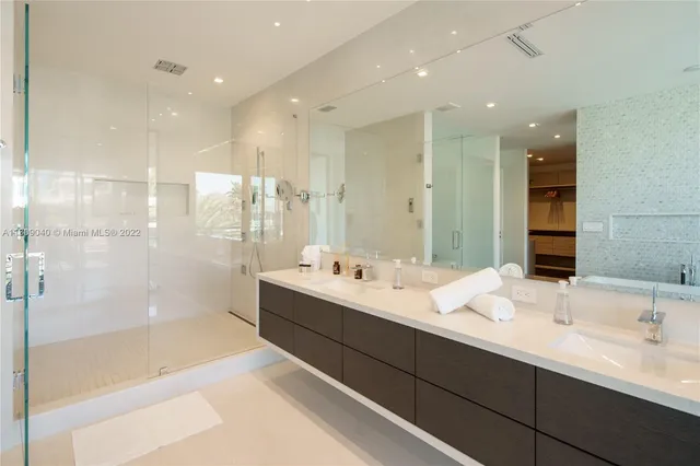 a bathroom with a sink a mirror and a shower
