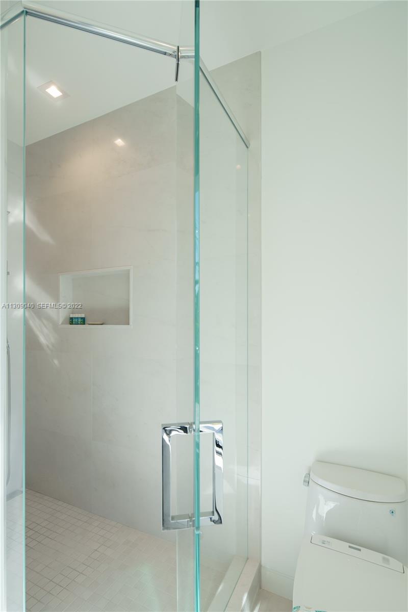 128 Fiesta Way Fort Lauderdale, FL 33301 - Photo 44 of 60 a bathroom with a shower and a toilet