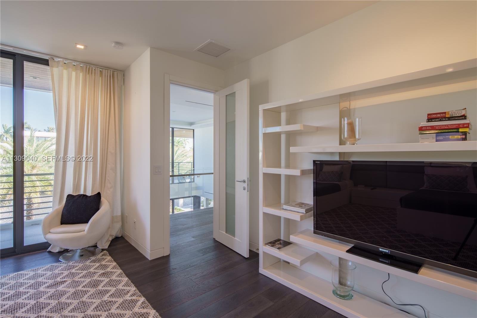 128 Fiesta Way Fort Lauderdale, FL 33301 - Photo 50 of 60 a living room with furniture and a fireplace