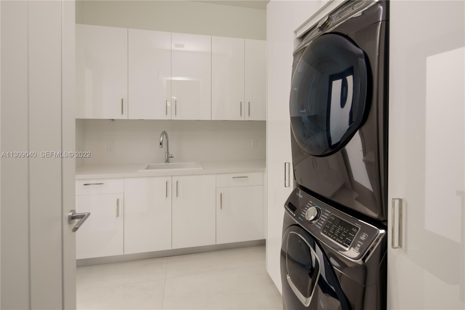 128 Fiesta Way Fort Lauderdale, FL 33301 - Photo 60 of 60 a utility room with dryer and washer