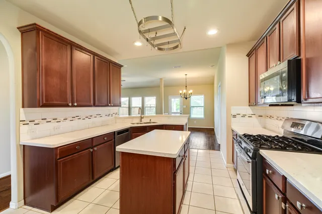 a kitchen with a sink stove and cabinets