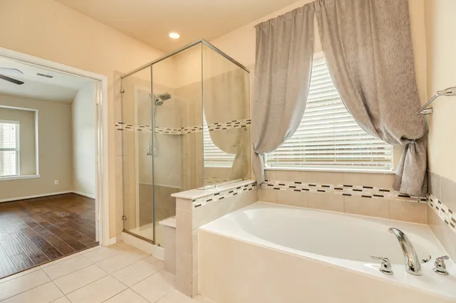 a bathroom with a bathtub and a shower