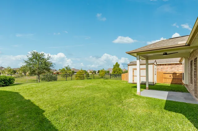 a view of a house with a yard and sitting area