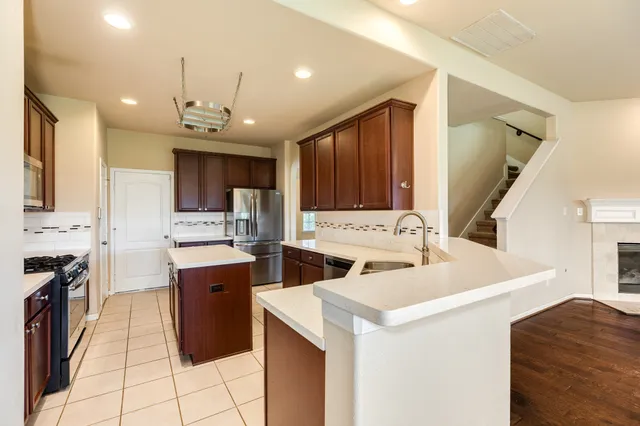 a kitchen that has a sink and a stove in it