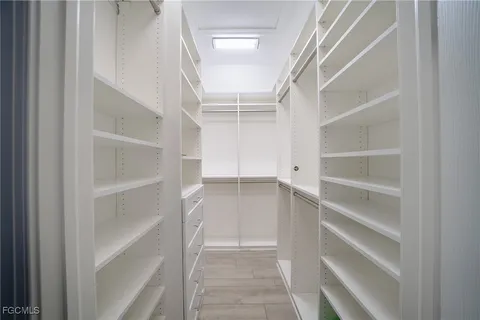 a view of walk in closet with empty racks