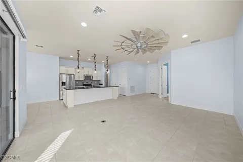 a view of a kitchen with a sink and chandelier fan