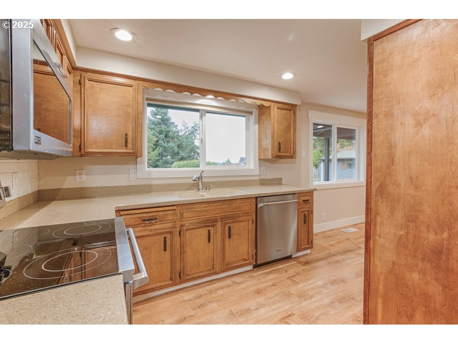 1735 Misty Place Northwest Salem, OR 97304 - Photo 14 of 31 a kitchen with kitchen island granite countertop a sink cabinets and window