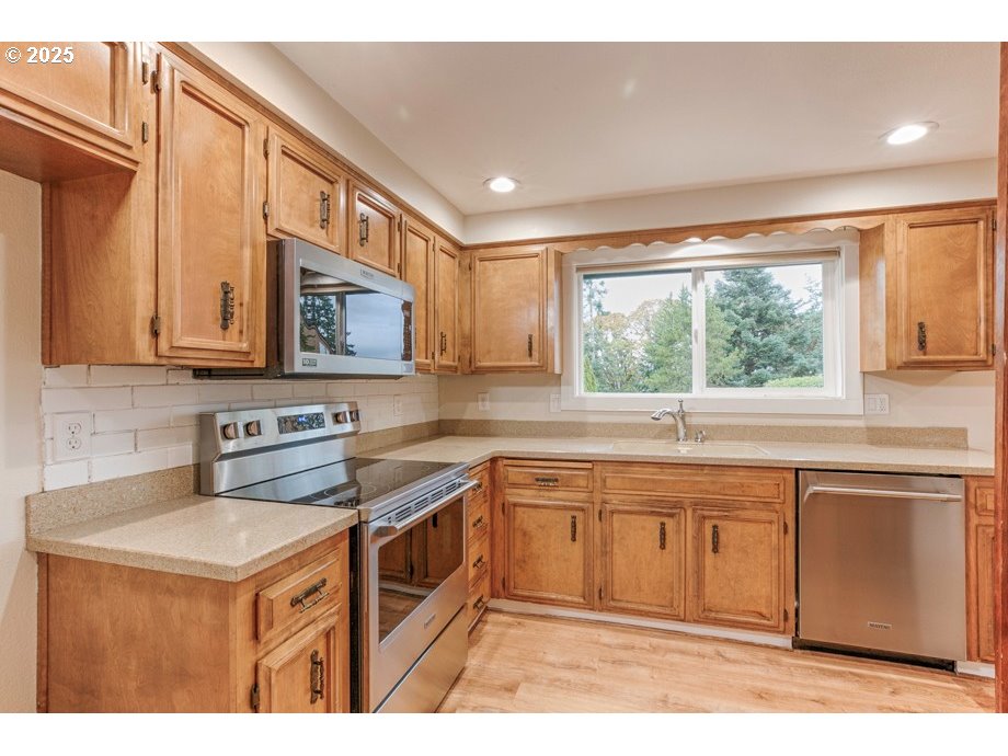 1735 Misty Place Northwest Salem, OR 97304 - Photo 15 of 31 a kitchen with a stove sink and cabinets