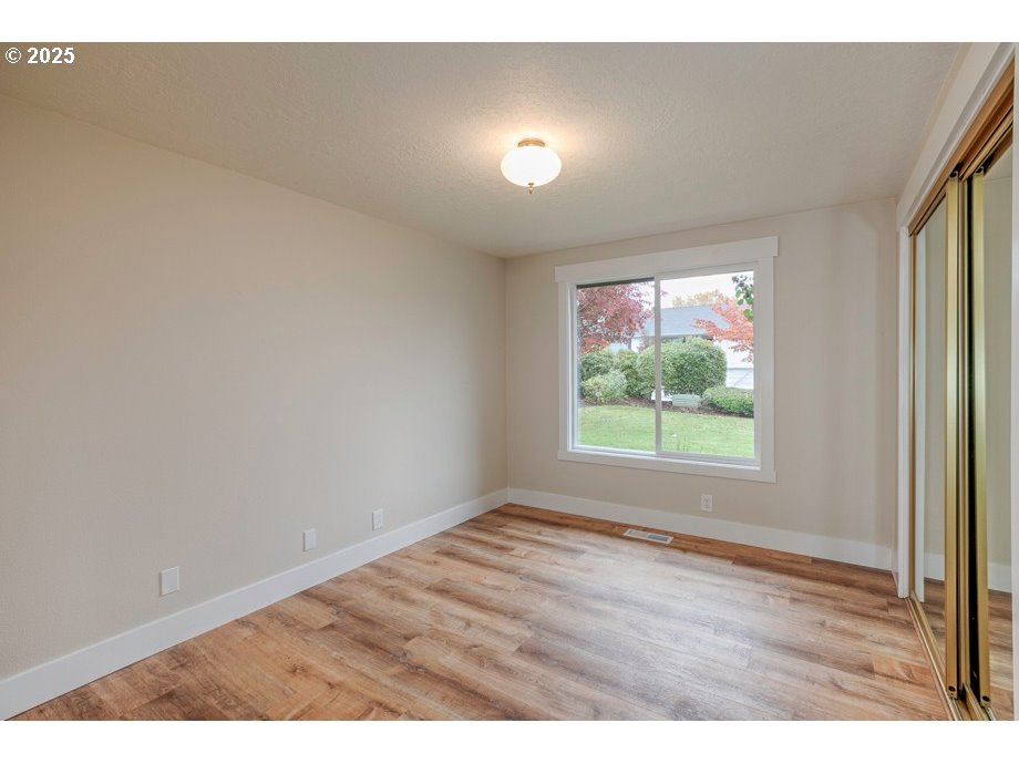 1735 Misty Place Northwest Salem, OR 97304 - Photo 16 of 31 an empty room with wooden floor and windows