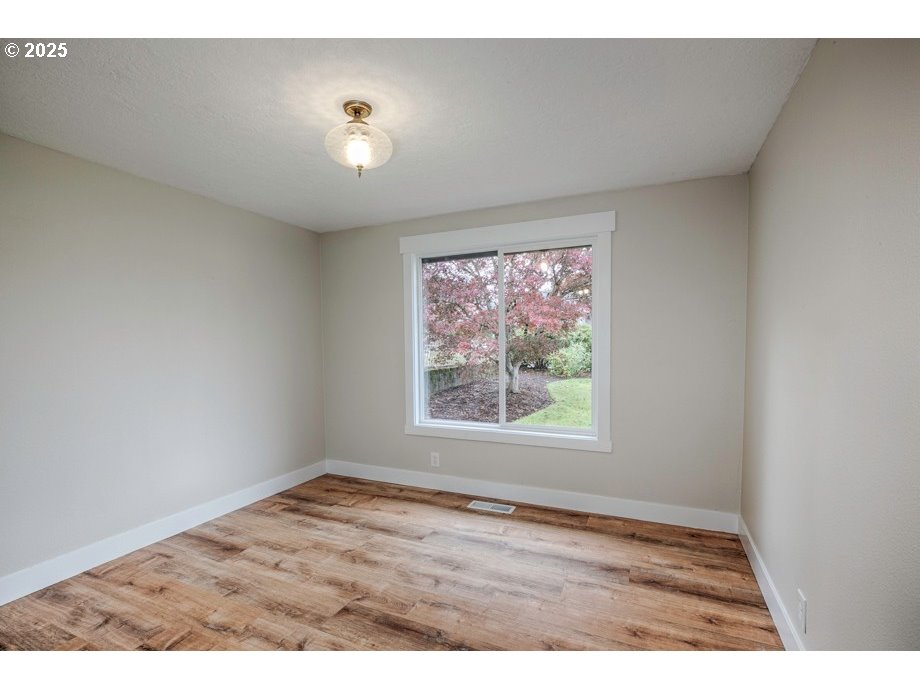 1735 Misty Place Northwest Salem, OR 97304 - Photo 17 of 31 a view of an empty room with wooden floor and a window