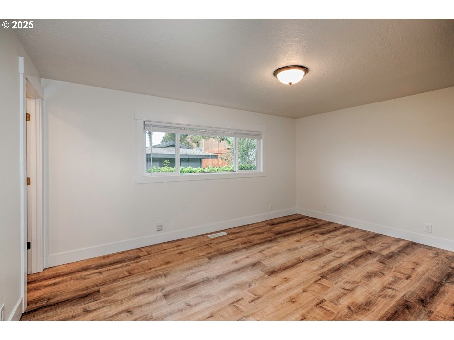 1735 Misty Place Northwest Salem, OR 97304 - Photo 19 of 31 a view of an empty room with wooden floor and a window