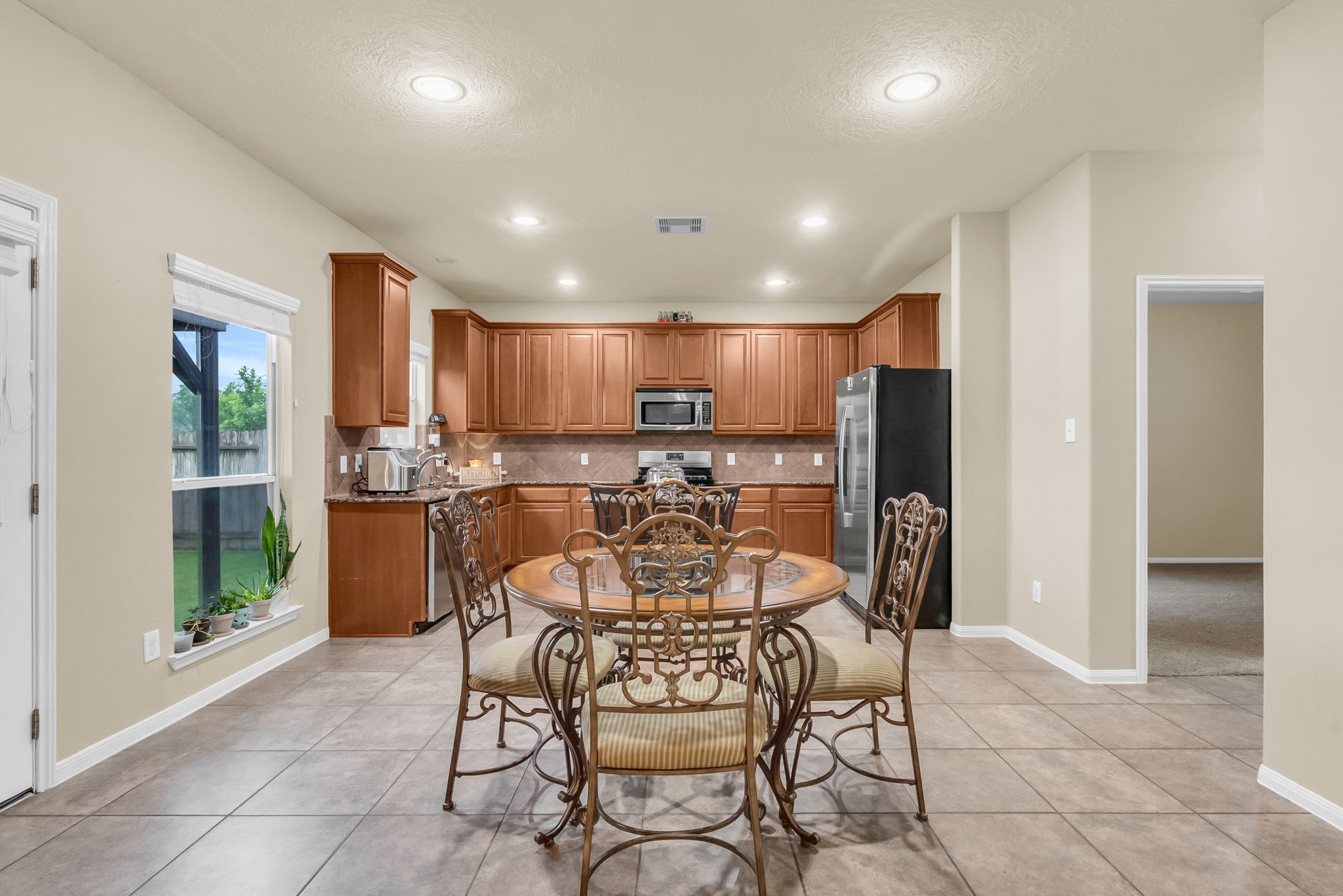 16619 Dover Mills Drive Spring, TX 77379 - Photo 15 of 49 a kitchen with a refrigerator and a dining table