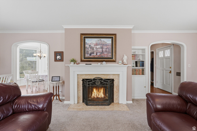 7576 South Jefferson Street Midvale, UT 84047 - Photo 8 of 53 Living area with a central fireplace featuring a stone surround and a white mantel
