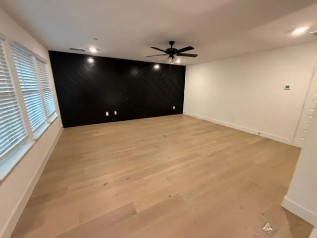 a view of an empty room with a ceiling fan