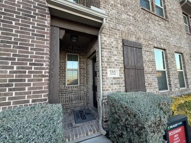 a view of a brick house with a large windows
