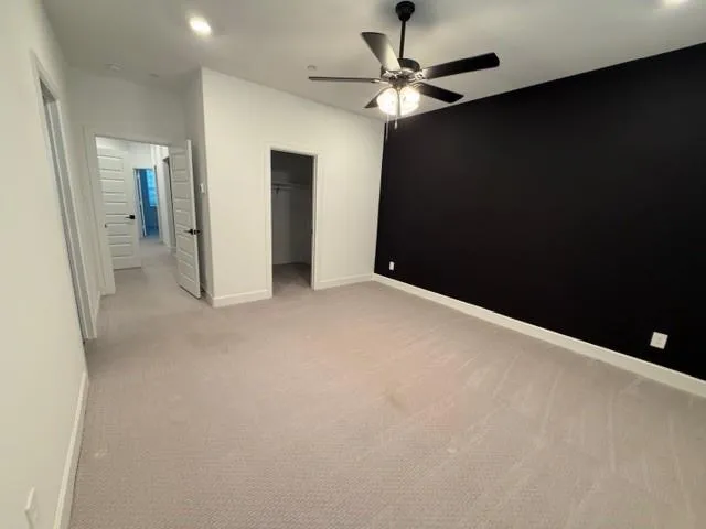 wooden floor in an empty room with a bathroom