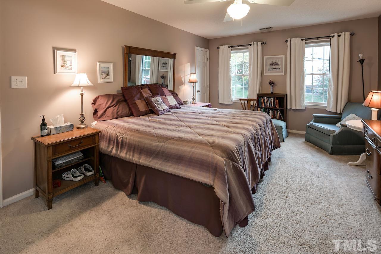 4 Cedar Hill Drive Durham, NC 27713 - Photo 11 of 49 a spacious bedroom with a bed and a couch