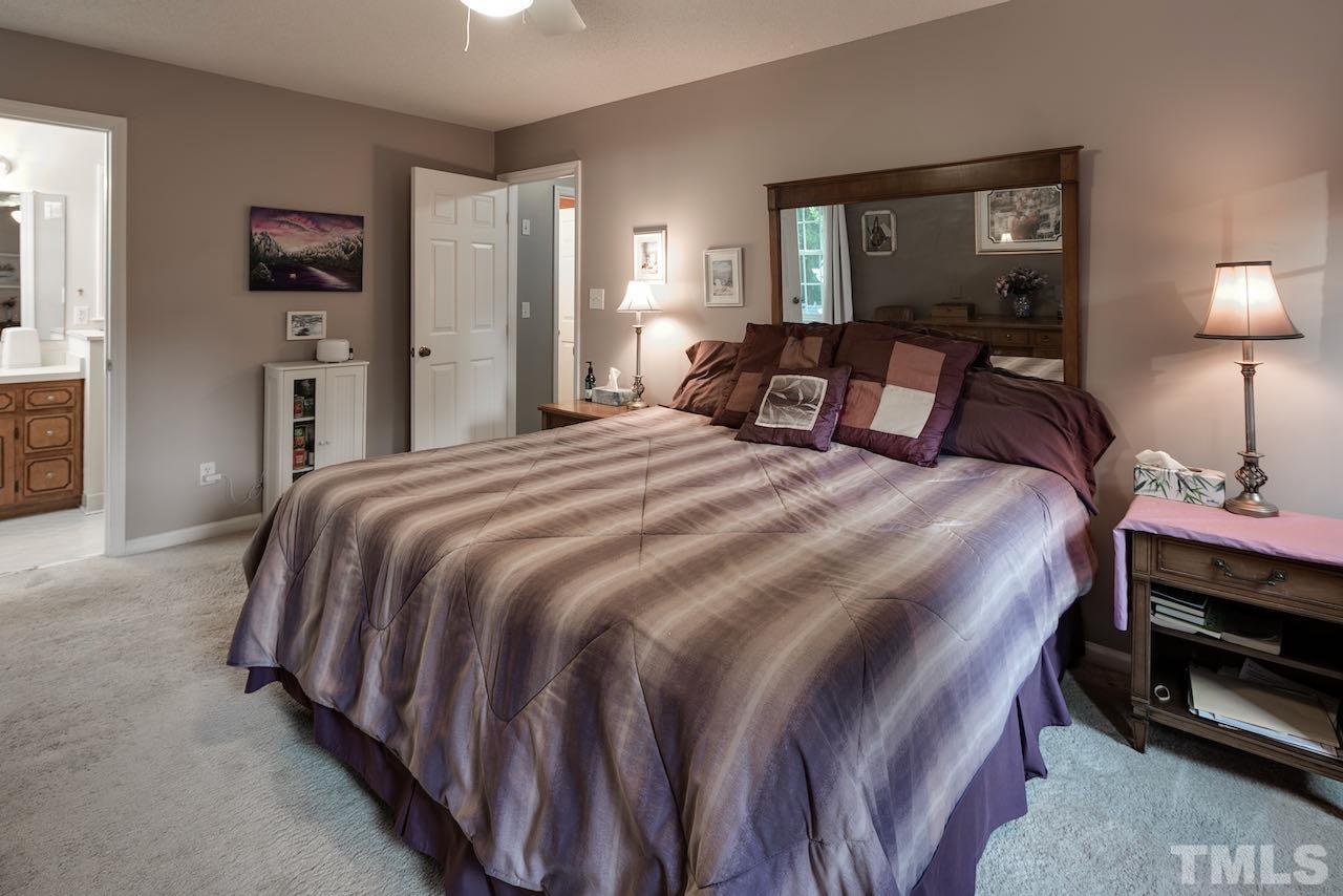 4 Cedar Hill Drive Durham, NC 27713 - Photo 12 of 49 a bedroom with a bed and a lamp