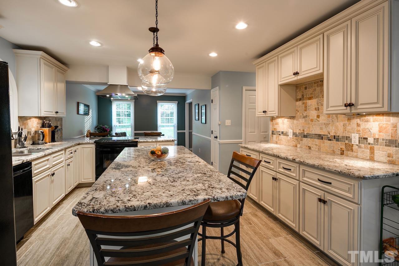 4 Cedar Hill Drive Durham, NC 27713 - Photo 6 of 49 a kitchen with stainless steel appliances granite countertop a sink stove and refrigerator