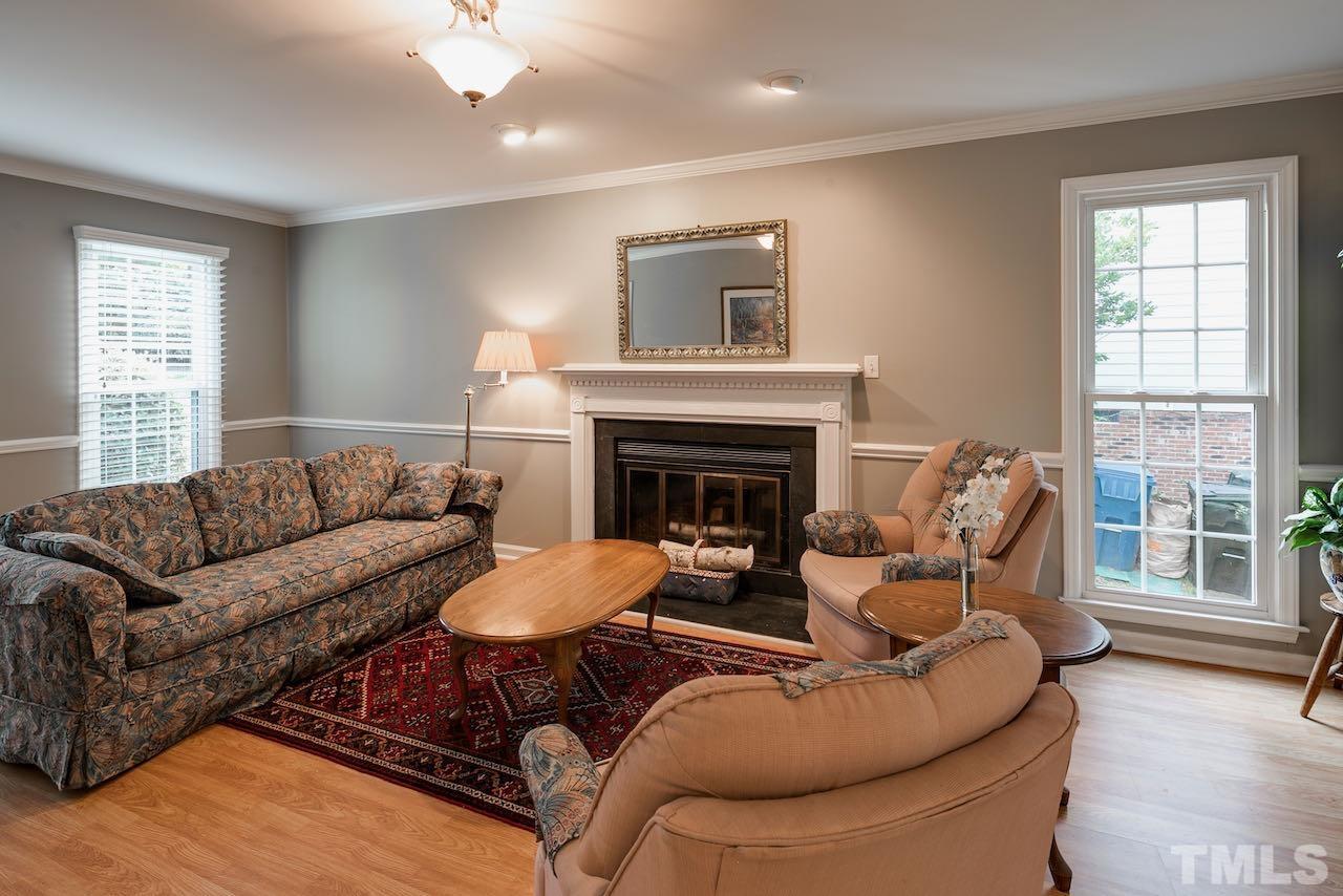 4 Cedar Hill Drive Durham, NC 27713 - Photo 10 of 49 a living room with furniture a fireplace and a large window