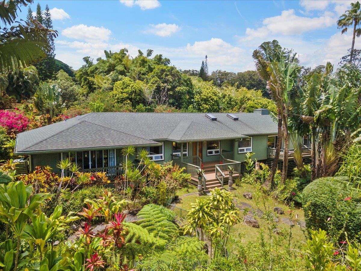 60 Koolau Road Haiku, HI 96708 - Photo 1 of 47 a front view of a house with a garden