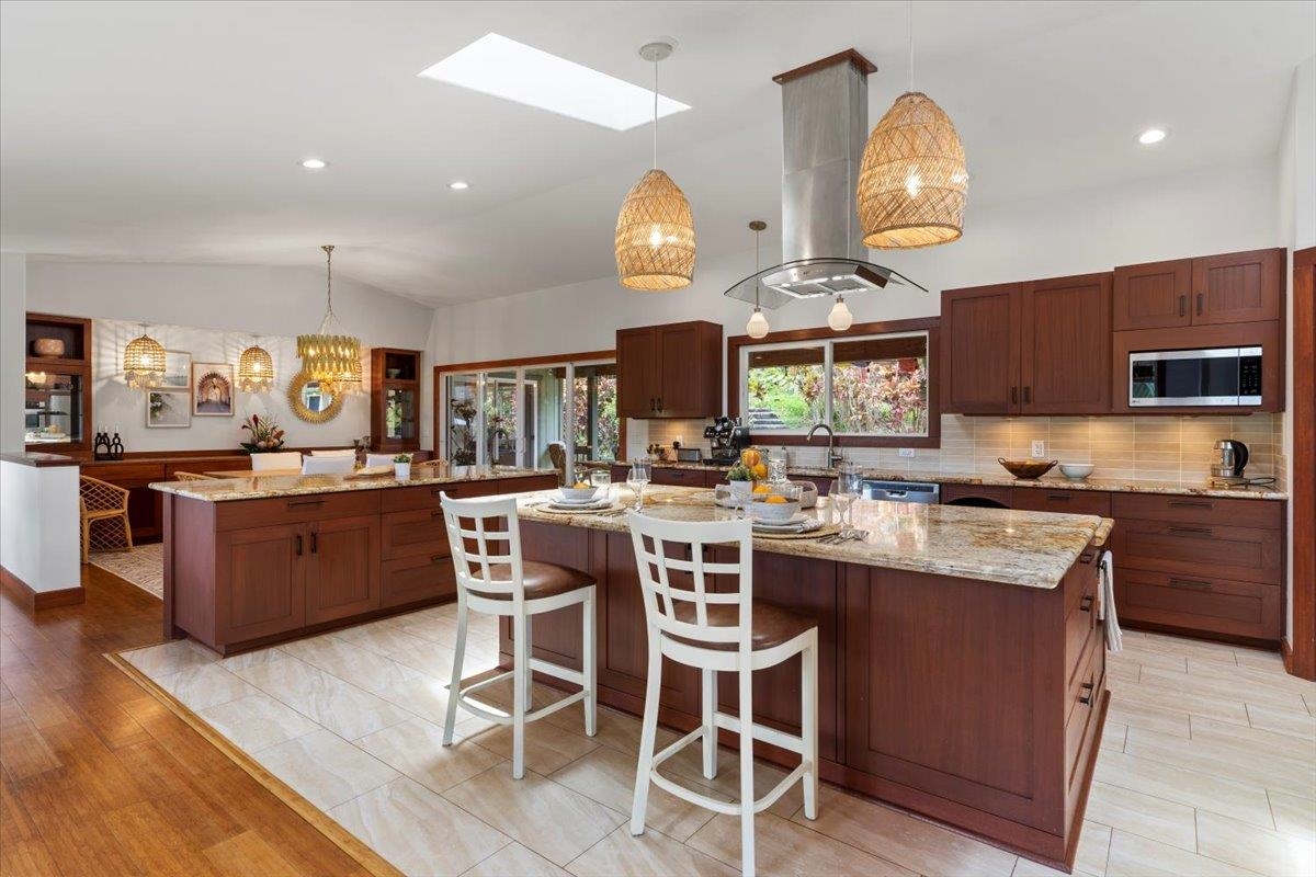60 Koolau Road Haiku, HI 96708 - Photo 11 of 47 a kitchen with cabinets a counter space appliances and a chandelier