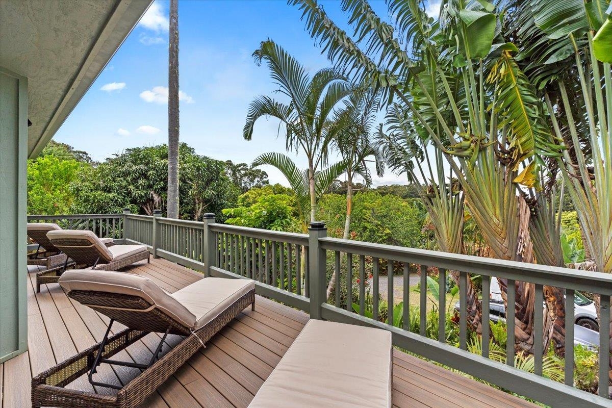 60 Koolau Road Haiku, HI 96708 - Photo 19 of 47 a view of a balcony with two chairs and a potted plant
