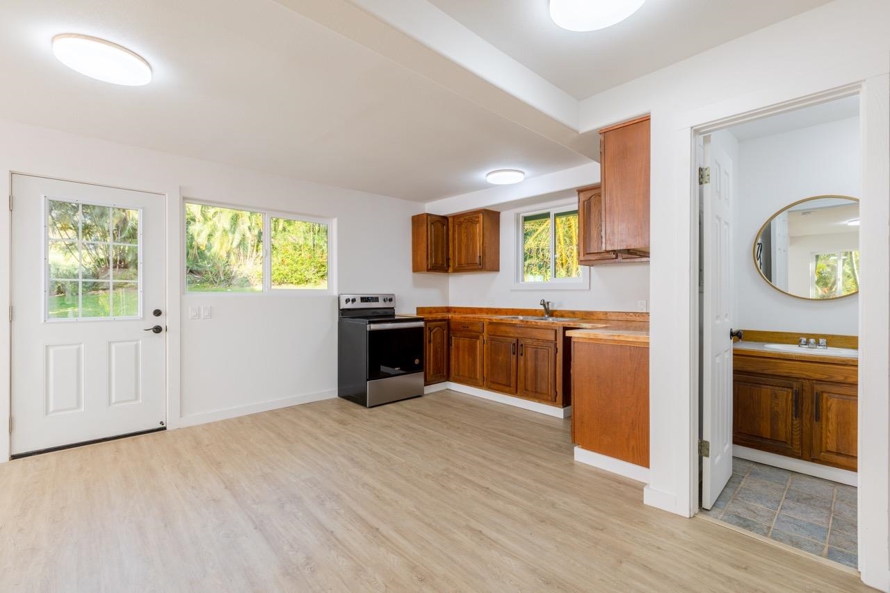 60 Koolau Road Haiku, HI 96708 - Photo 43 of 47 a kitchen with granite countertop a stove top oven sink and cabinets