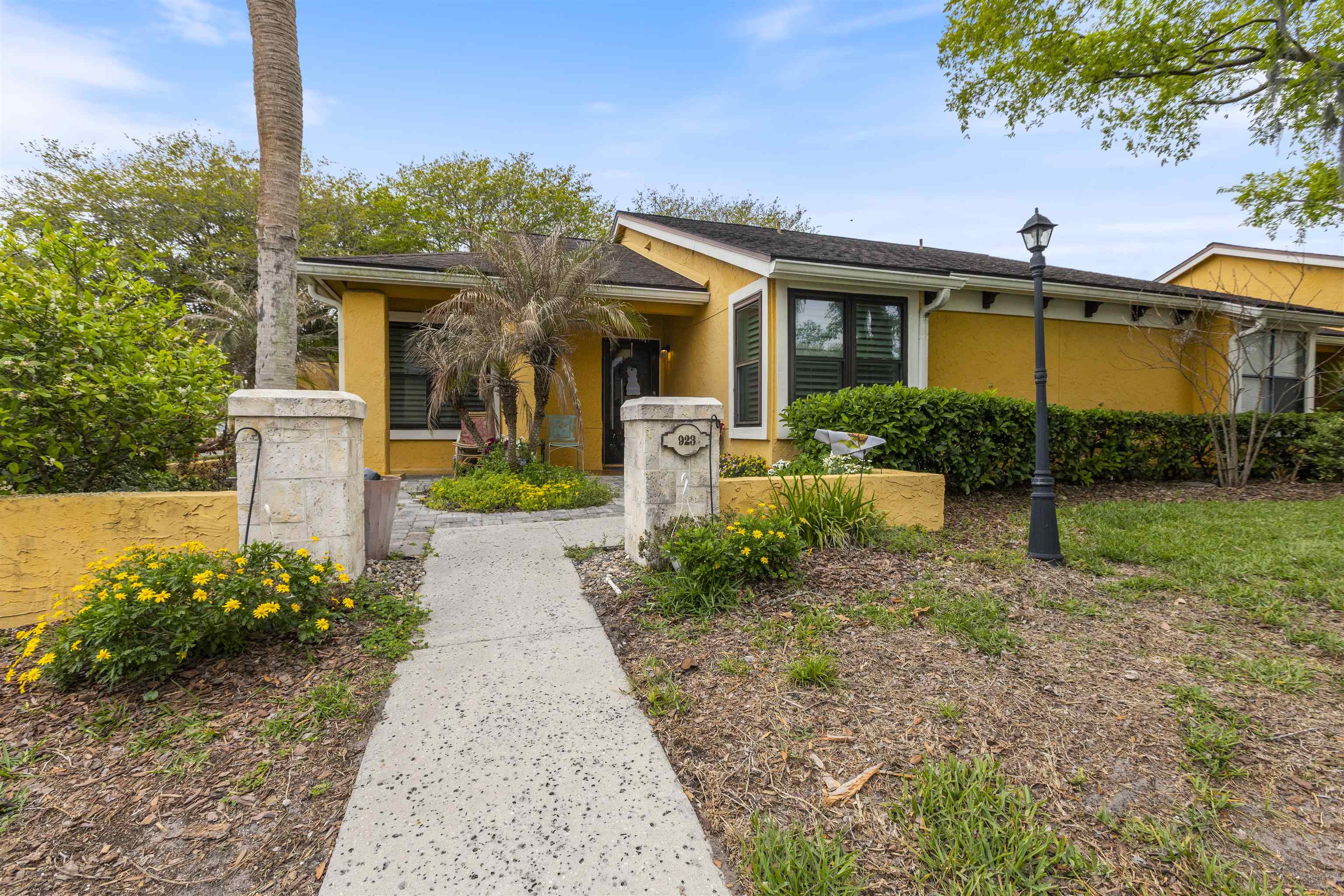 923 Seashell Lane Ponte Vedra Beach, FL 32082 - Photo 2 of 60 a front view of a house with garden