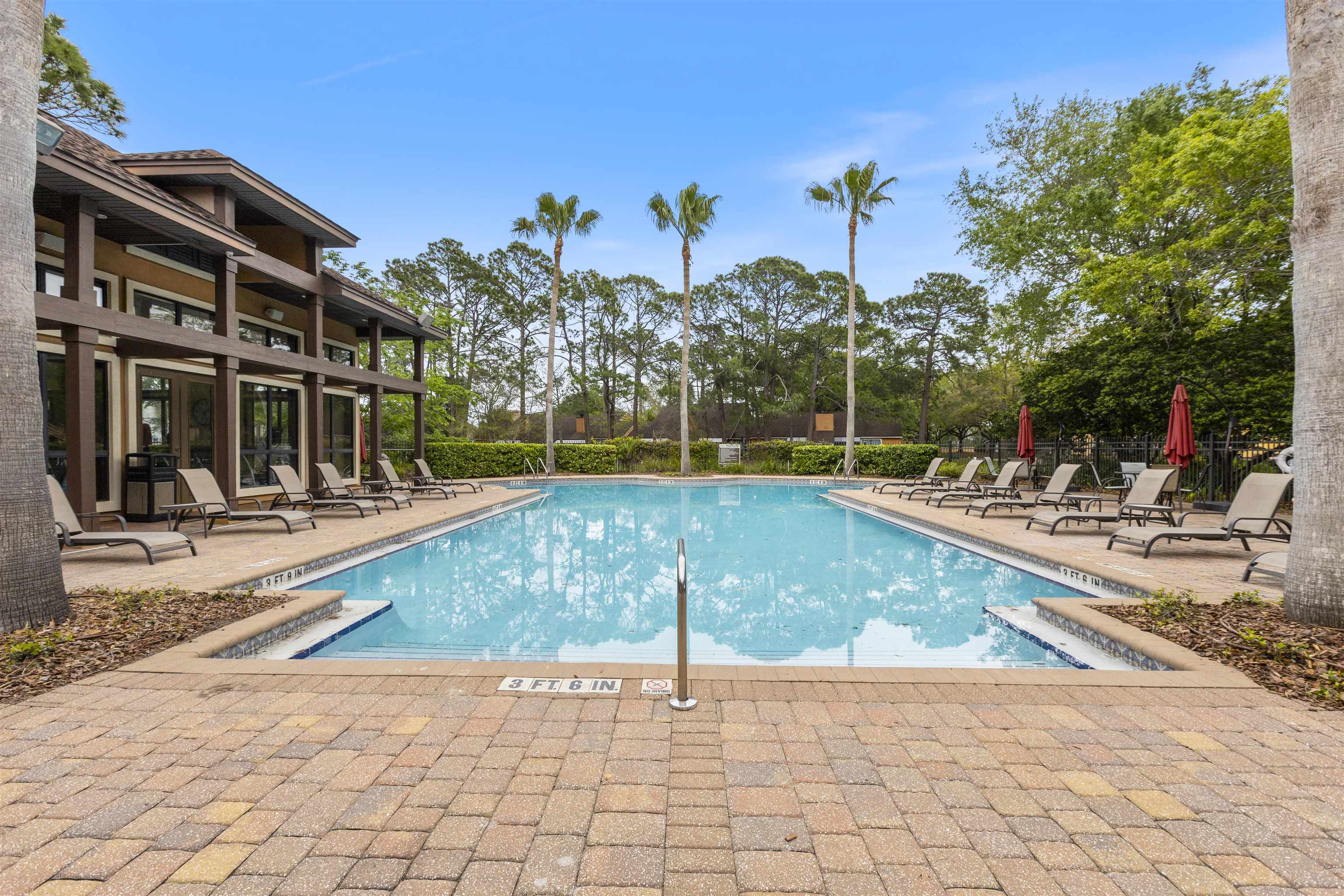 923 Seashell Lane Ponte Vedra Beach, FL 32082 - Photo 57 of 60 a view of a swimming pool with a lounge chairs