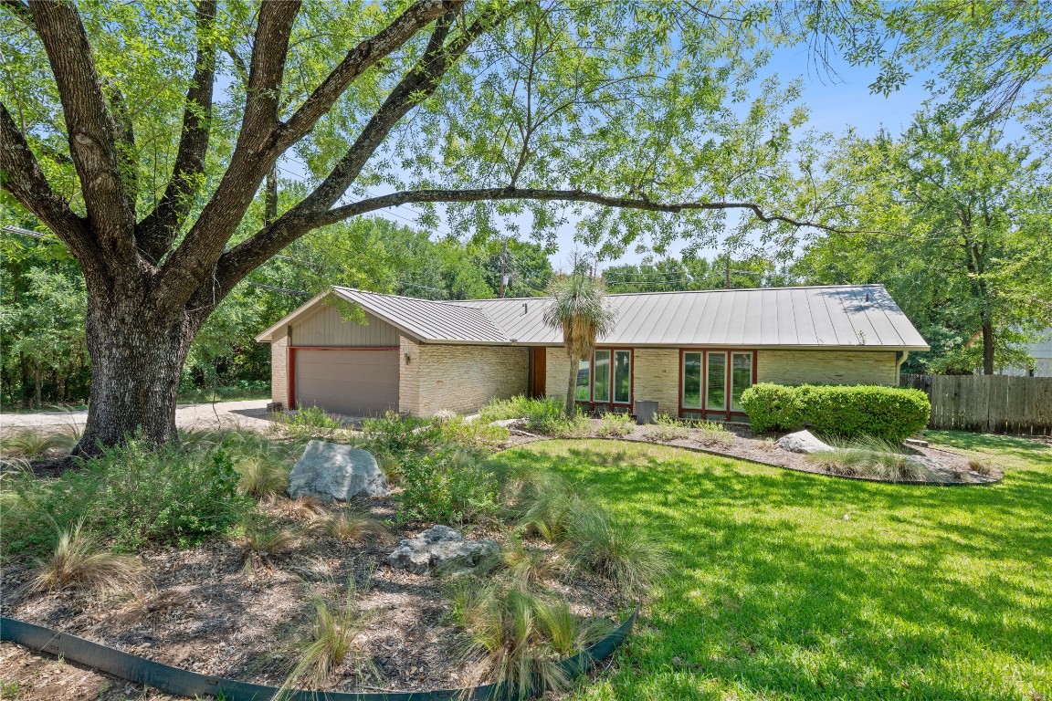 1407 Spring Garden Road Austin, TX 78746 - Photo 1 of 28 a view of a house with a yard and large tree