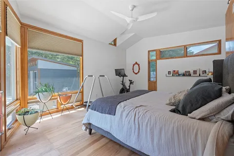 a bedroom with a bed and glass door