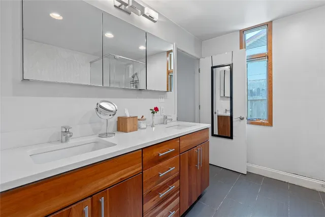 a kitchen with stainless steel appliances granite countertop a sink a stove and a refrigerator