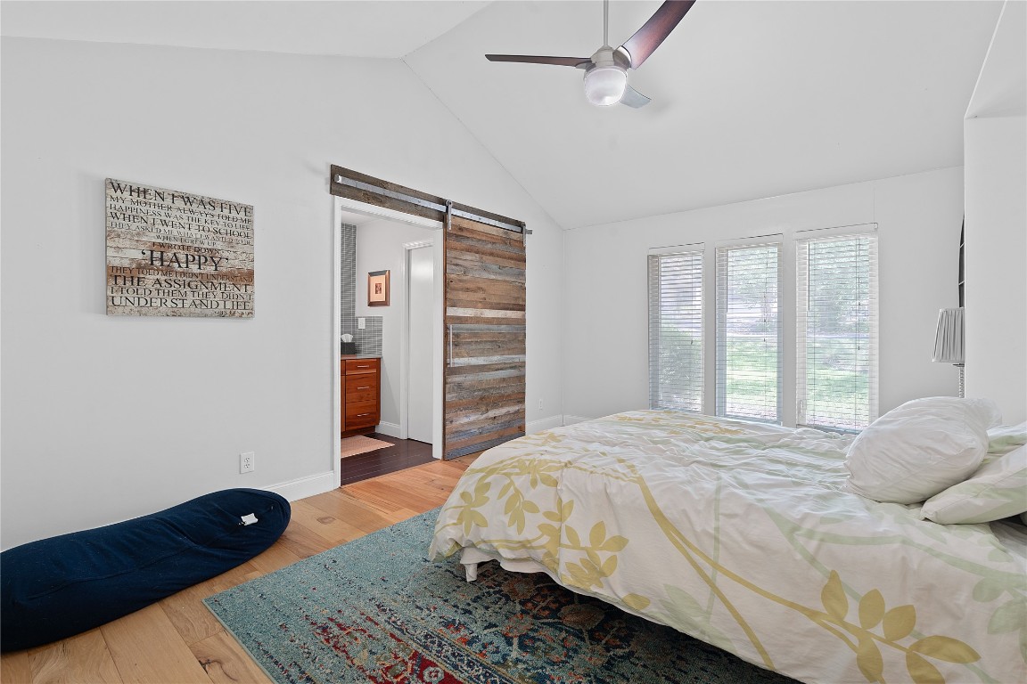 1407 Spring Garden Road Austin, TX 78746 - Photo 18 of 28 a bedroom with a bed dresser and a window