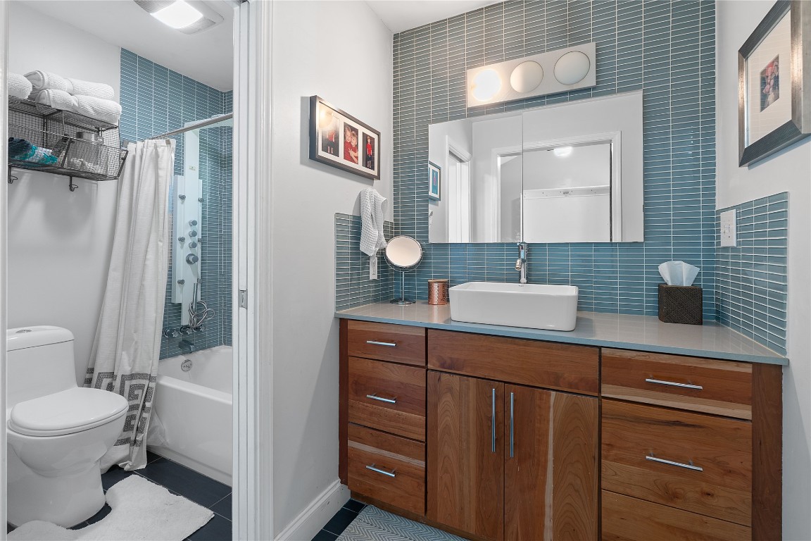 1407 Spring Garden Road Austin, TX 78746 - Photo 20 of 28 a bathroom with a sink a toilet and shower